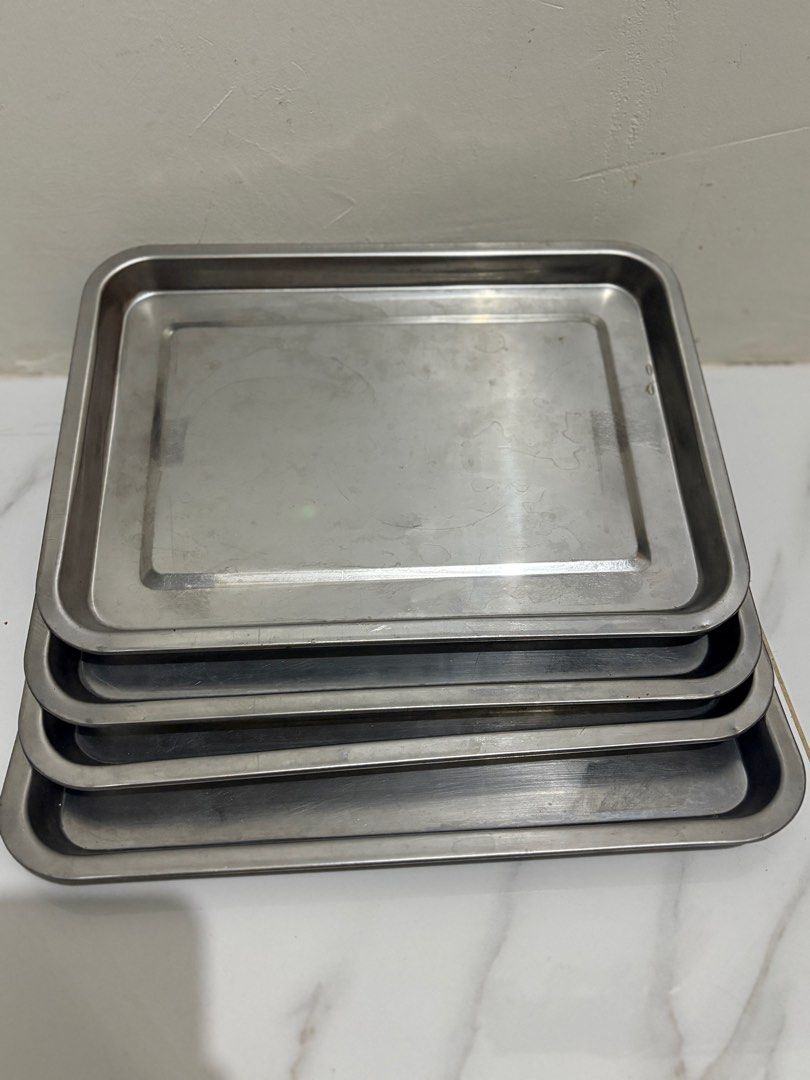 555 Stainless Steel Baking Trays (Category: Bakeware) located in Pasig City. Submitted by katetatin (Listing ID 1413995303, Image 1). Description: - Set of stainless steel baking trays - Rectangular shape with slightly raised edges - Stackable design for easy storage - Minor marks on the surface - Versatile for baking, serving, and general kitchen tasks -100 each available 2 pcs - Size: 36x27.