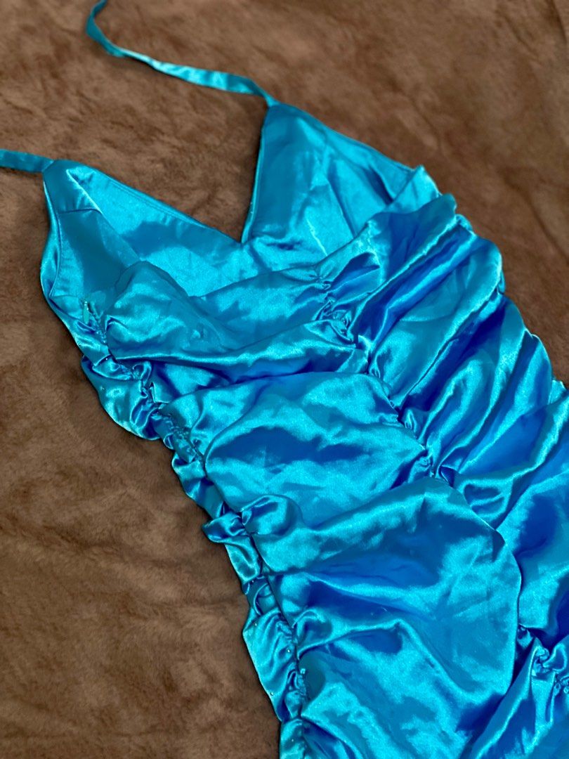 Blue Satin Halter Ruffled Dress (Category: Dresses) located in Taguig. Submitted by prelobyjen (Listing ID 1413889822, Image 3). Description: - Blue halter dress - Ruched bodice - Fitted silhouette - Tiered skirt - Subtle embellishments/stuss - Side zipper closure - Ideal for special occasions.