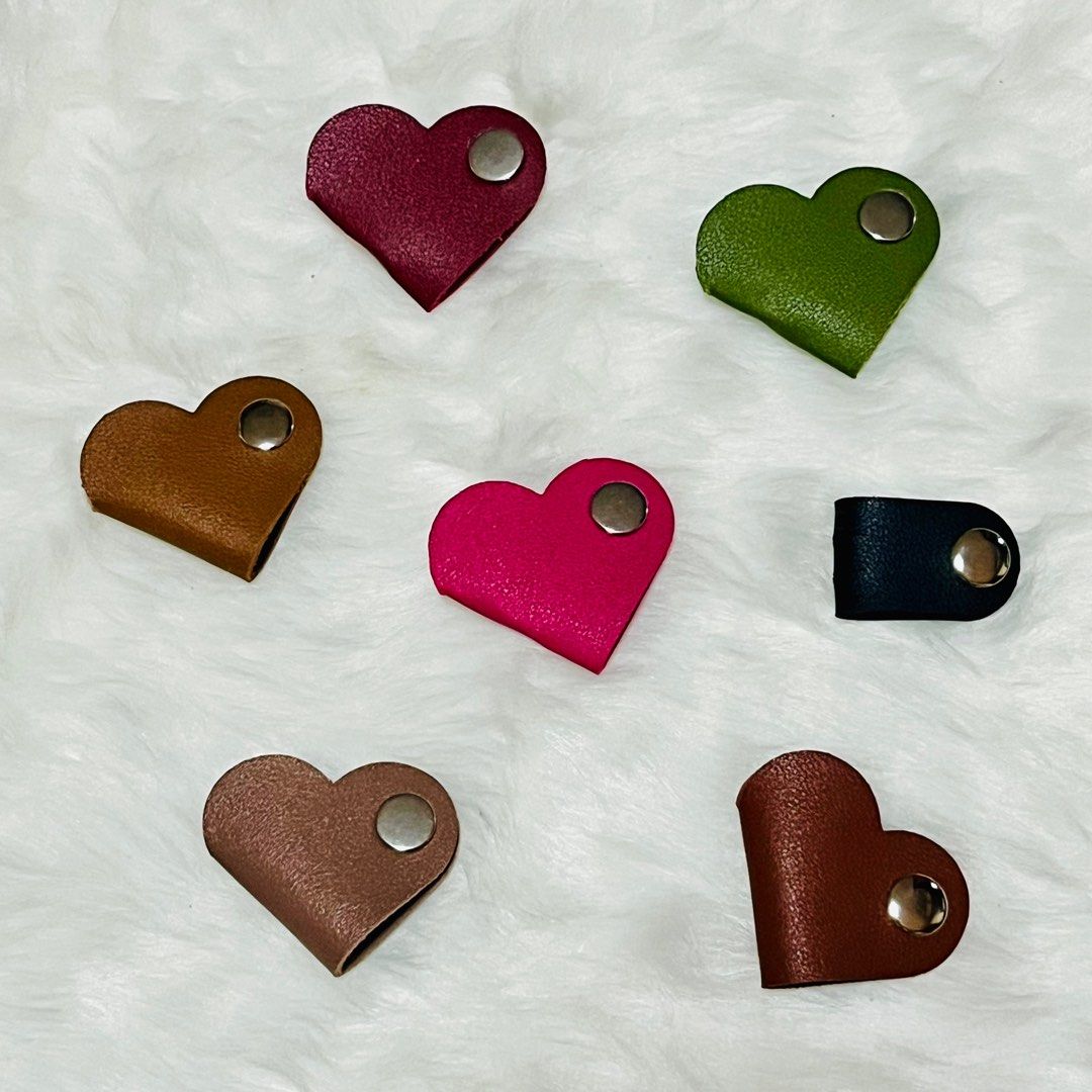 Cable Organizers Cord Holder (Category: Storage Boxes & Baskets) located in Dasmarinas. Submitted by wisermommashoppe (Listing ID 1413916991, Image 1). Description: - Heart-shaped & simple cable organizers - Features a snap closure - Keeps your cables tidy and organized.