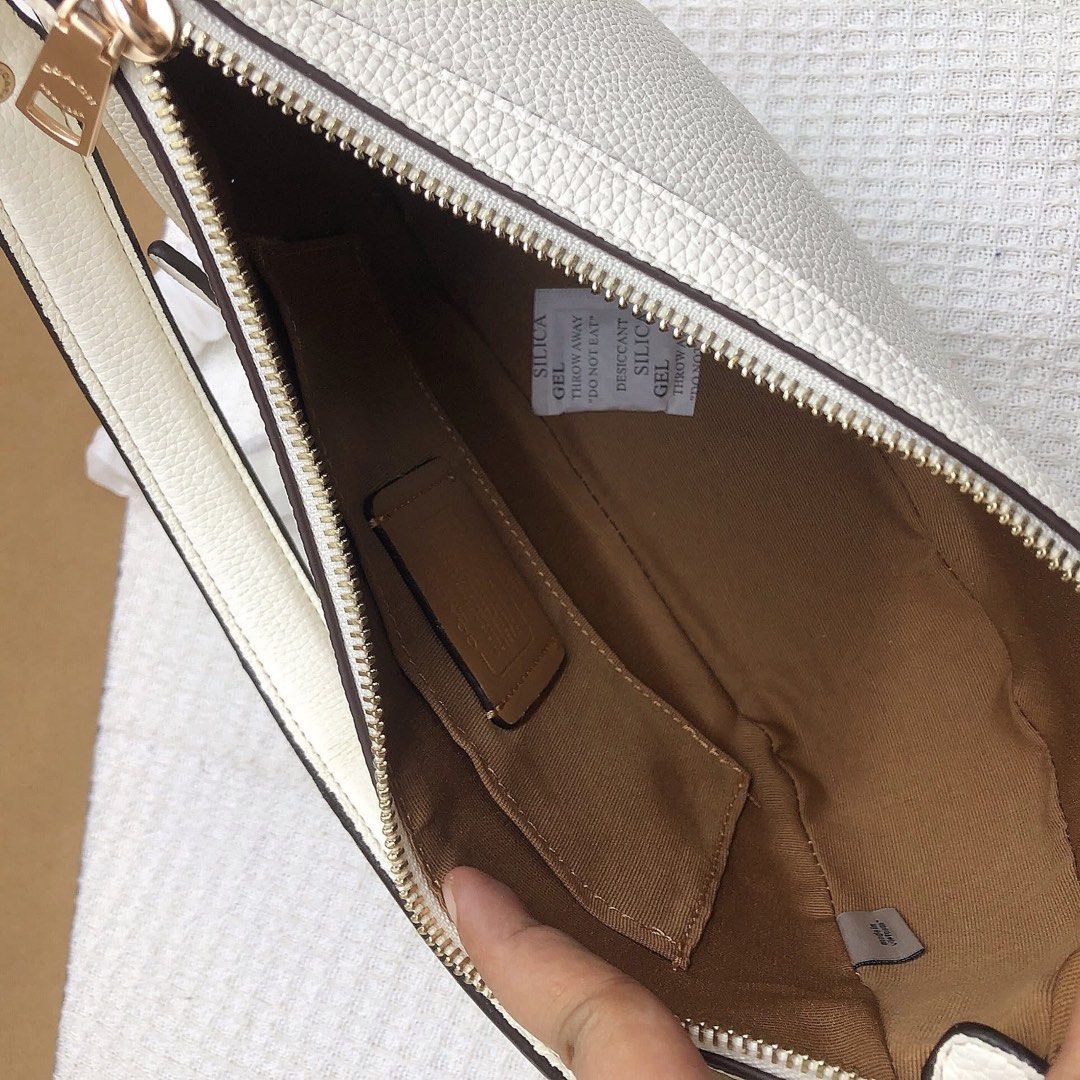 Coach New York Crescent Bag (Category: Luxury Bags & Wallets) located in Manila. Submitted by clairetot (Listing ID 1414023551, Image 2). Description: Coach New York Crescent Bag - Top zipper closure - Interior small pocket - Detachable shoulder strap - Gold-tone hardware - Includes Coach New York tag - Comes with Coach paper bag.