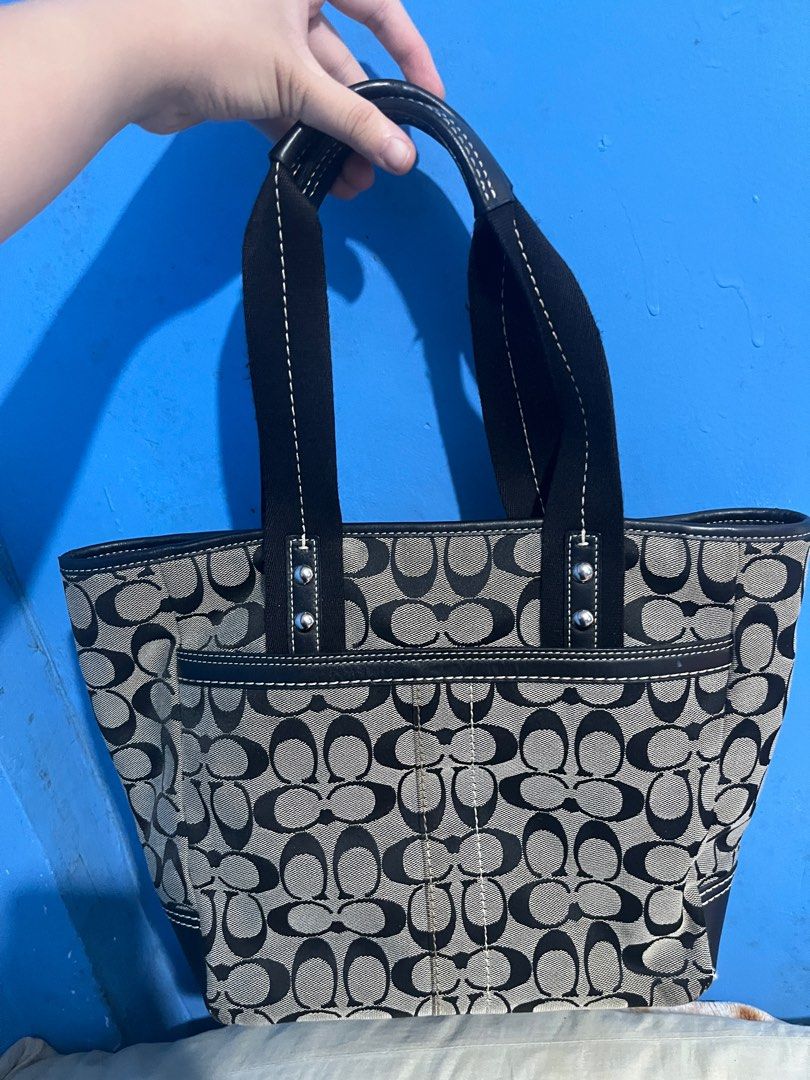 Coach Vintage Tote Bag (Category: Luxury Bags & Wallets) located in Manila. Submitted by empanadaaaaaa (Listing ID 1413938798, Image 2). Description: - Coach tote bag - Signature pattern - Black leather trim and handles - Includes Coach hang tag - Interior: zippered pocket and Coach leather tag - Front pocket - Spacious main compartment - Black leather bottom.
