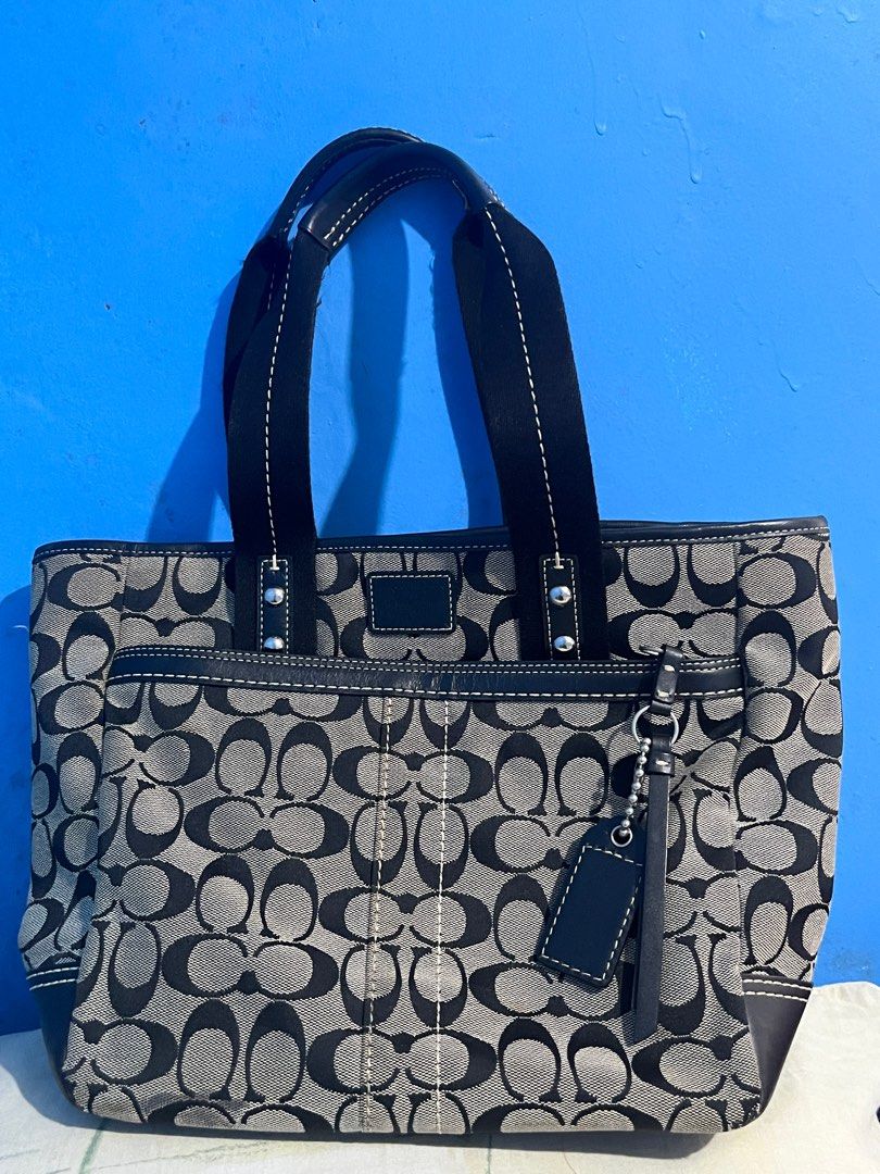 Coach Vintage Tote Bag (Category: Luxury Bags & Wallets) located in Manila. Submitted by empanadaaaaaa (Listing ID 1413938798, Image 1). Description: - Coach tote bag - Signature pattern - Black leather trim and handles - Includes Coach hang tag - Interior: zippered pocket and Coach leather tag - Front pocket - Spacious main compartment - Black leather bottom.