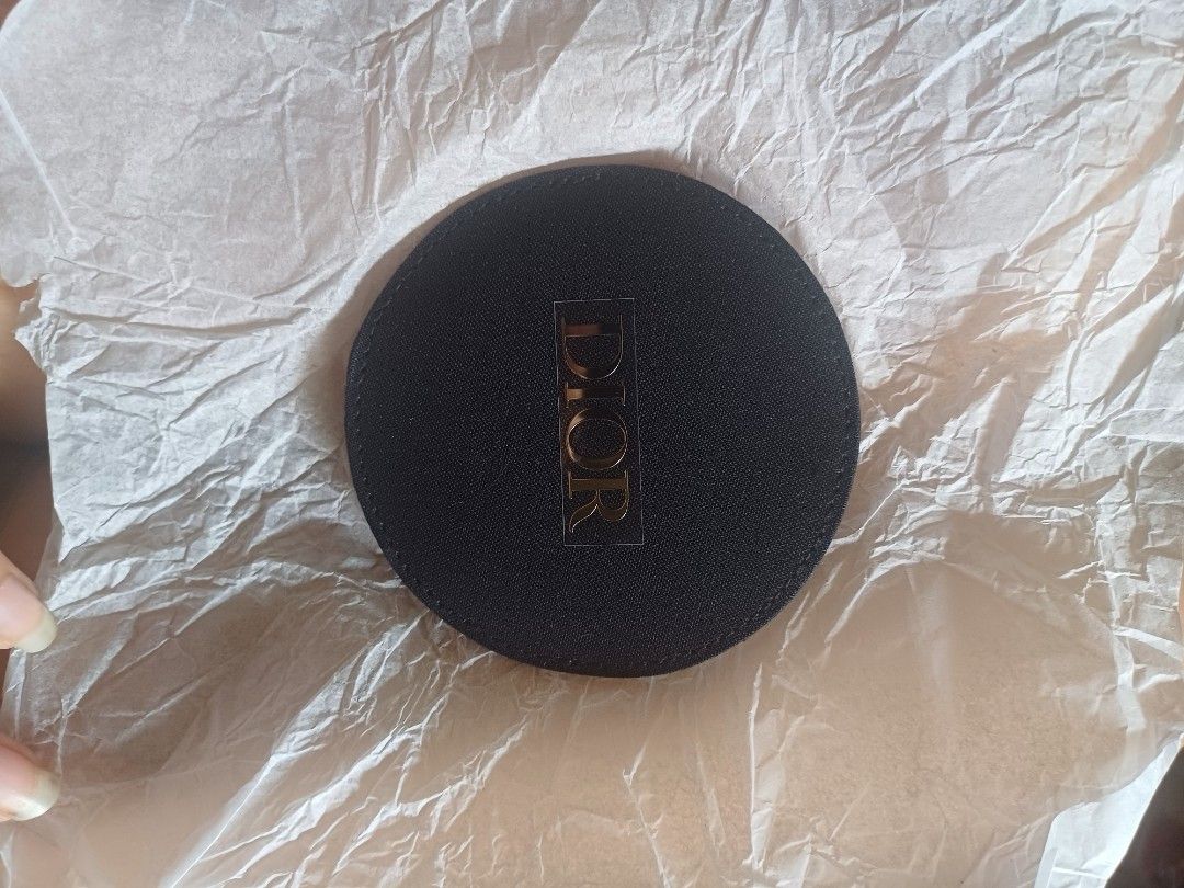 Dior Compact Mirror (Category: Face Care) located in Caloocan City. Submitted by feldsparky89171 (Listing ID 1413999333, Image 1). Description: Dior compact mirror. The mirror is round and has a black fabric exterior with the Dior logo. It comes with a matching black fabric case. The mirror is small and portable, perfect for on-the-go touch-ups..
