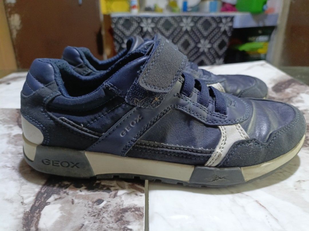 Geox Navy Blue Sneakers - Size 36 (Category: Sneakers) located in Caloocan City. Submitted by gorebria (Listing ID 1414022267, Image 3). Description: Geox navy blue sneakers. Features a hook-and-loop strap with the Geox logo. The shoes have a combination of leather and suede materials. The size is indicated as 36. The shoes have a navy blue color with white accents..