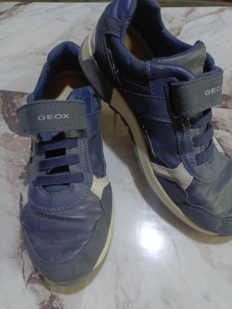 Geox Navy Blue Sneakers - Size 36 (Category: Sneakers) located in Caloocan City. Submitted by gorebria (Listing ID 1414022267, Image 2). Description: Geox navy blue sneakers. Features a hook-and-loop strap with the Geox logo. The shoes have a combination of leather and suede materials. The size is indicated as 36. The shoes have a navy blue color with white accents..