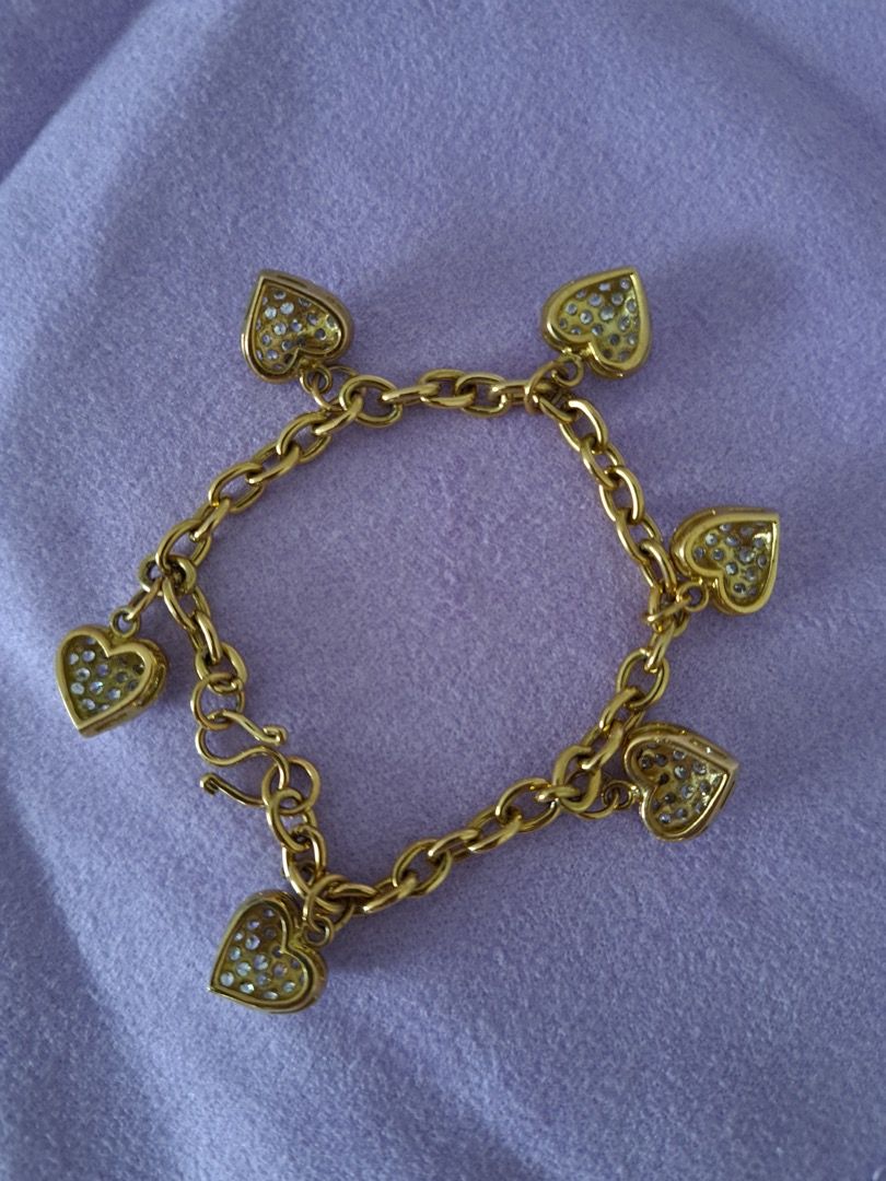 Gold Heart Charm Bracelet (Category: Bracelets) located in Makati City. Submitted by myredbag (Listing ID 1413896031, Image 3). Description: - Gold bracelet - Features multiple heart charms - Charms encrusted with small, sparkling stones - Classic chain design - Hook clasp - Delicate and elegant.
