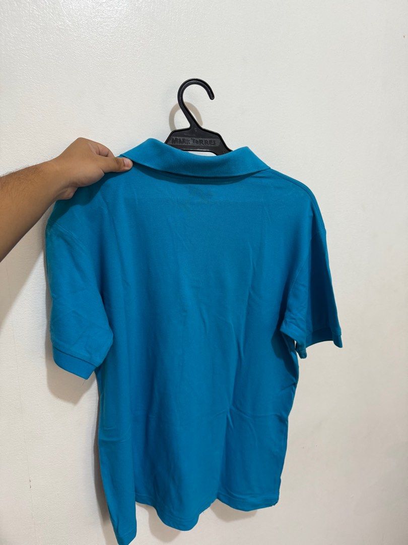 Lacoste Blue Polo Shirt (Category: Tshirts & Polo Shirts ) located in Quezon City. Submitted by artdeclutters_ (Listing ID 1413924050, Image 2). Description: Rfs: Not using anymore, decluttering DM for Dimensions MoP: GCash/Cash Courier: To be booked by buyer/available for pick-up More details: - Authentic Lacoste polo shirt - Vibrant turqoise blue color - Size 4 - Iconic Lacoste crocodile logo - Classic polo collar and short sleeves - Comfortabl