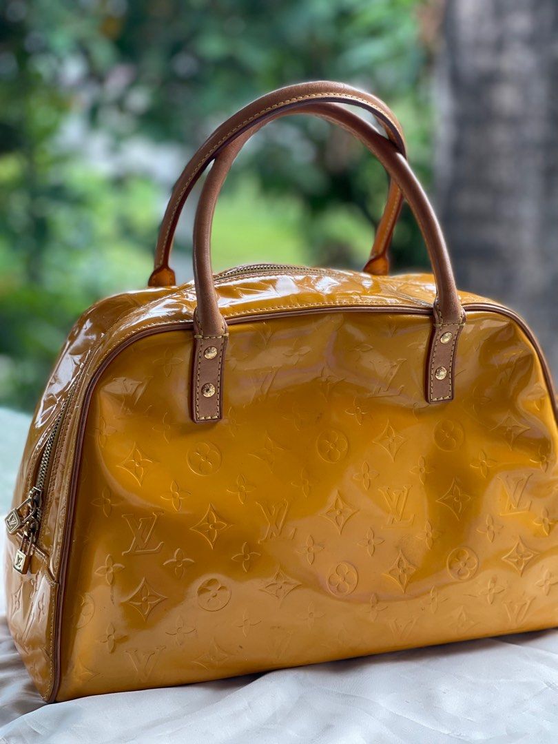 Louis Vuitton Vernis Deauville (Category: Luxury Bags & Wallets) located in San Fernando. Submitted by wayweworeph (Listing ID 1413861508, Image 2). Description: - Authentic Louis Vuitton Deauville handbag - Stunning mustard yellow color - Glossy Vernis leather with LV monogram - Secure top zipper closure - Comfortable double handles - Includes a small padlock - Matching yellow leather interior - Made in France -bought in Japan in the early 200s 