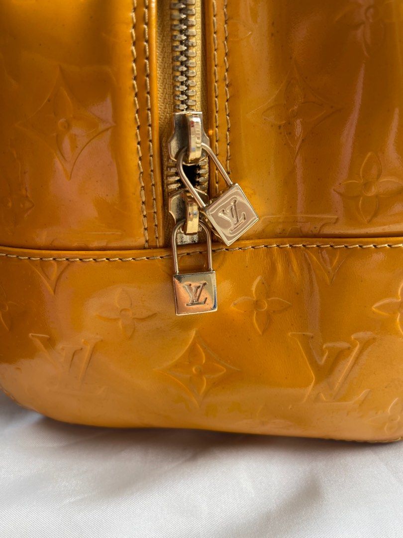 Louis Vuitton Vernis Deauville (Category: Luxury Bags & Wallets) located in San Fernando. Submitted by wayweworeph (Listing ID 1413861508, Image 3). Description: - Authentic Louis Vuitton Deauville handbag - Stunning mustard yellow color - Glossy Vernis leather with LV monogram - Secure top zipper closure - Comfortable double handles - Includes a small padlock - Matching yellow leather interior - Made in France -bought in Japan in the early 200s 