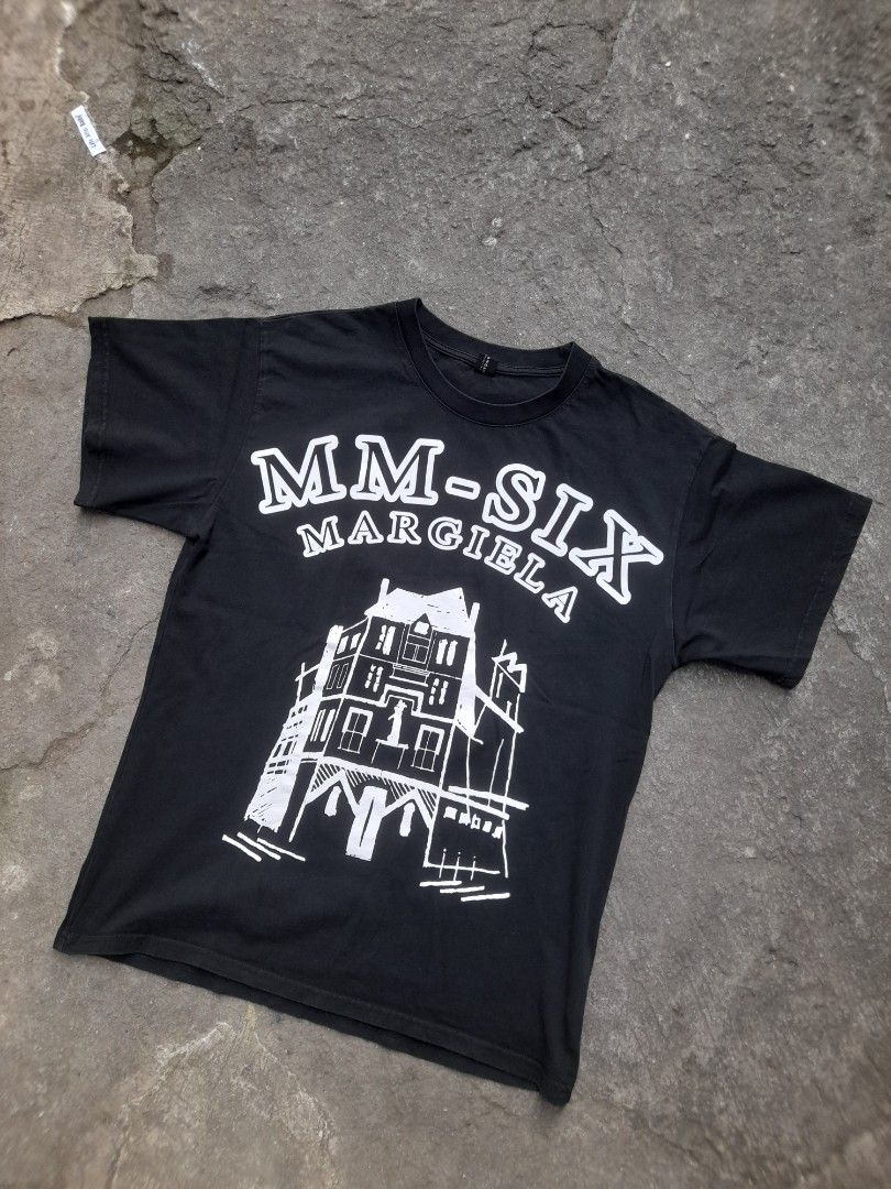 MM6 Maison Margiela Black Graphic Tee(OFF) (Category: Tshirts & Polo Shirts ) located in Taguig. Submitted by sebas_tian (Listing ID 1413866294, Image 1). Description: DIMES: 19.5x26 10/10 color rate color may vary due to lighting - MM6 Maison Margiela t-shirt - Black color - Features a graphic print with brand name and house illustration - Crew neck and short sleeves - Made of soft fabric - Ideal for casual wear - Stylish and comfortable.