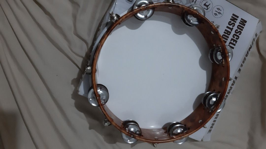 Muscell Percussion 10-inch Tambourine (Category: Musical Instruments) located in Cainta. Submitted by alpaca19 (Listing ID 1413874968, Image 2). Description: - Muscell Percussion Tambourine - 10-inch tunable design - White drumhead - Wooden frame - Metal jingles - Double row jingles - Perfect for adding percussion to your music!.