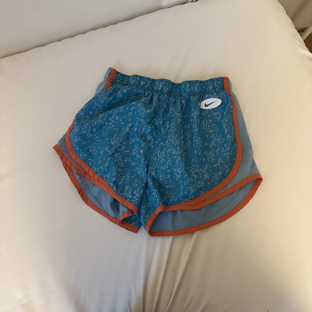 Nike Dri-FIT Running Shorts (Category: Activewear) located in Makati City. Submitted by marcheu (Listing ID 1414052547, Image 1). Description: - Nike Dri-FIT running shorts - Color: Blue with orange trim - Size: Medium (M) - Features: White Nike logo, inner lining, and elastic waistband - Has panty.