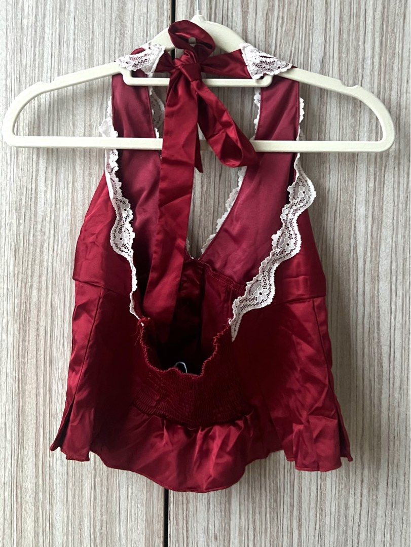 [ONHAND] Pacsun ~ Bella Lace Trim Halter Top Red (Category: Sleeveless) located in Cebu City. Submitted by angel.energyph2 (Listing ID 1413887151, Image 3). Description: 🏷️ ₱1200 Size XS Waist 33-34” Hip 25-26” - Brand new without tag - Silky woven fabric - Plunging v-neckline with lace trim - Button front placket - Pleated bodice with ruffled hem - Open back design - Adjustable halter strap - Smocked back detail - Slightly cropped length.