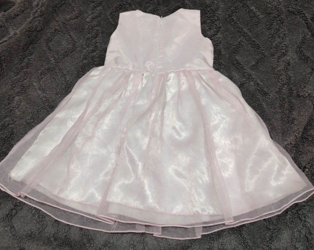 Pink Dress with Bow (Category: Babies & Kids Fashion) located in Rizal. Submitted by zhellieme (Listing ID 1413965125, Image 2). Description: Lovely pink dress features a sleeveless design and a delicate bow detail. It has a layered skirt, and a gold-colored belt. The dress is suitable for parties or special occasions. It has a zipper closure at the back. .