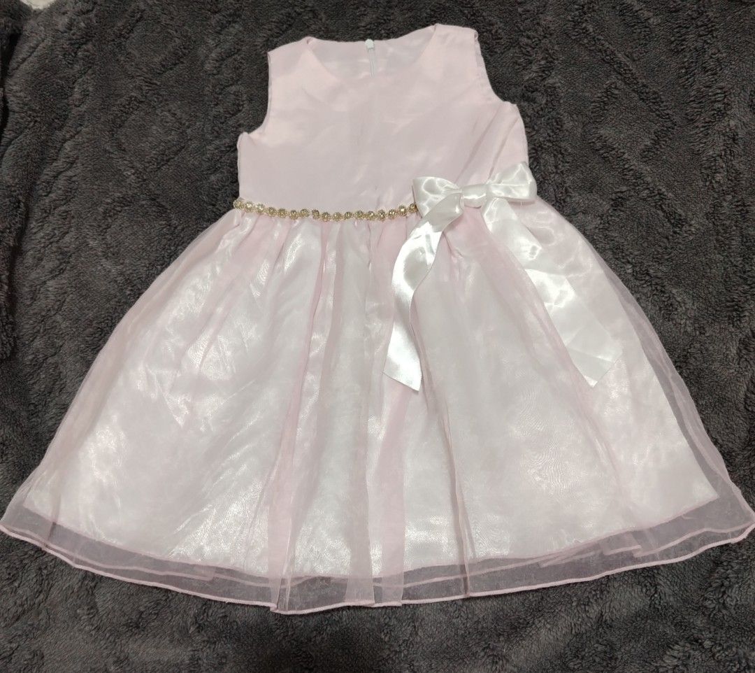 Pink Dress with Bow (Category: Babies & Kids Fashion) located in Rizal. Submitted by zhellieme (Listing ID 1413965125, Image 1). Description: Lovely pink dress features a sleeveless design and a delicate bow detail. It has a layered skirt, and a gold-colored belt. The dress is suitable for parties or special occasions. It has a zipper closure at the back. .