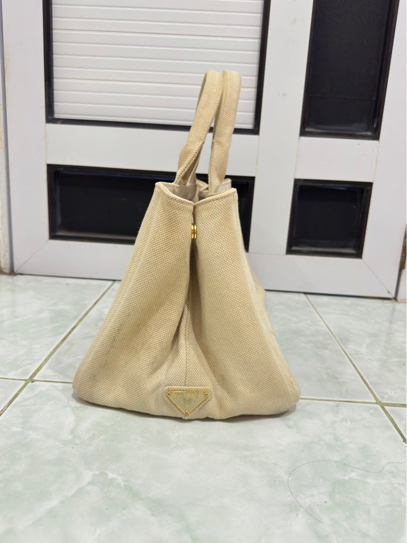 Authentic Prada Canapa White Tote Bag (Category: Luxury Bags & Wallets) located in Cabanatuan. Submitted by calliethrifts (Listing ID 1414027306, Image 2). Description: AUTHENTIC with Dust Bag Issues: • Normal Signs of Usage.