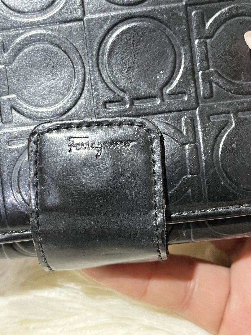 Salvatore Ferragamo Black Wallet (Category: Luxury Bags & Wallets) located in Mati. Submitted by CrestChancebyIFT (Listing ID 1414047138, Image 3). Description: - Black Salvatore Ferragamo wallet - Clasp closure - Textured pattern with logo - Multiple compartments for cards and cash - Clear ID window - Snap closure - Small flap with brand name.
