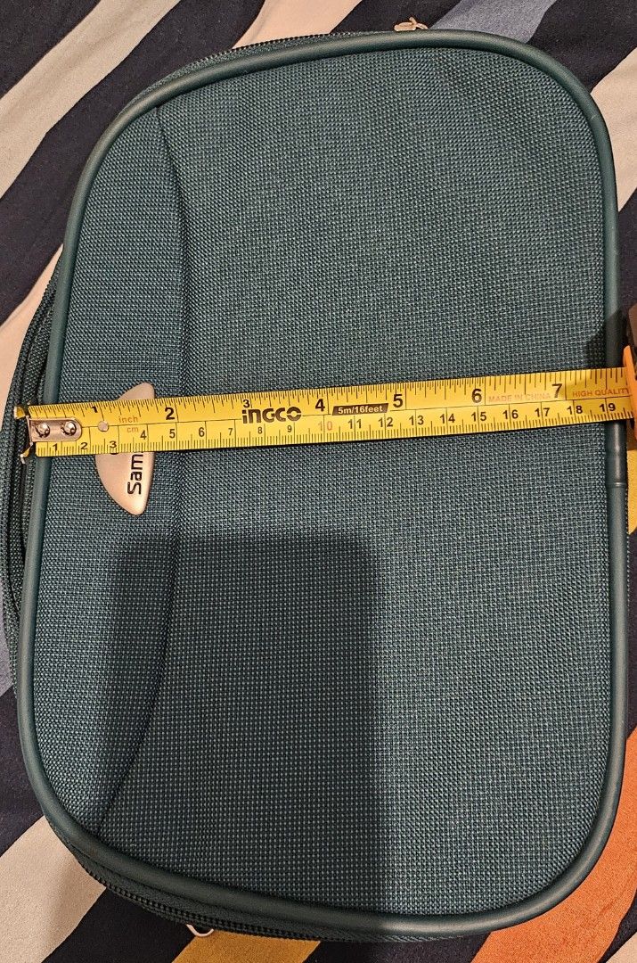 Samsonite Green Travel Bag (Category: Luxury Bags & Wallets) located in Quezon City. Submitted by johnsandhens (Listing ID 1413910991, Image 3). Description: - Green Samsonite travel bag - Top handle for easy carrying - Secure zippered closure - Oval shape - Made of durable fabric - Interior with multiple compartments for organization - Dimensions: Approximately 11 inches (length) x 7 inches (width).