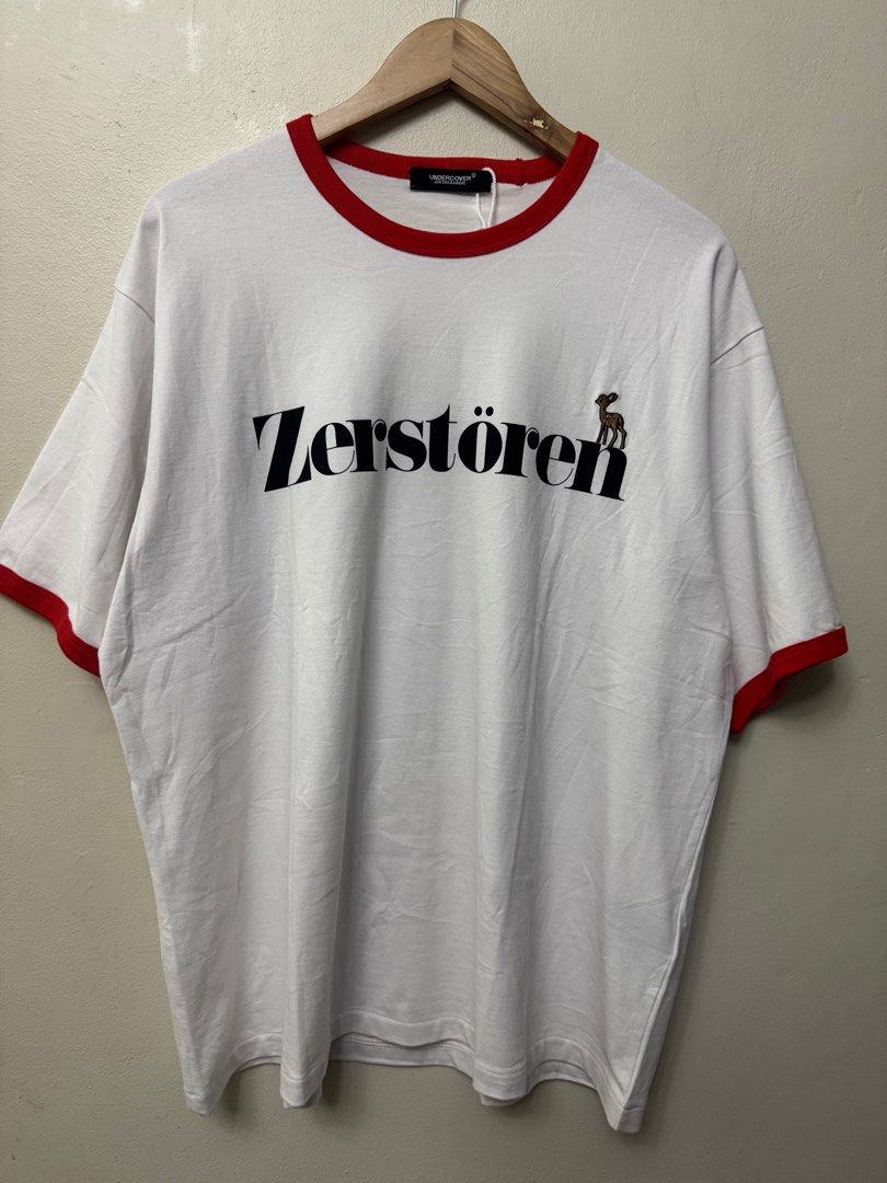 Undercover Japan Oversize Ringer Tee - White/Red (Category: Luxury Apparel) located in Dasmarinas. Submitted by phamhannii (Listing ID 1414013082, Image 3). Description: Undercover Japan by Jun Takahashi - Zerstören Graphic Oversize Ringer Tee 100% Cotton Size: 2 on tag Dimes (WxL): 24 x 28.5 inches Color Rate: 10/10 Condition Rate: 9.8/10 Excellent Condition (dot stain on belly area) All items are washed and sanitized. Flexible payment options. 