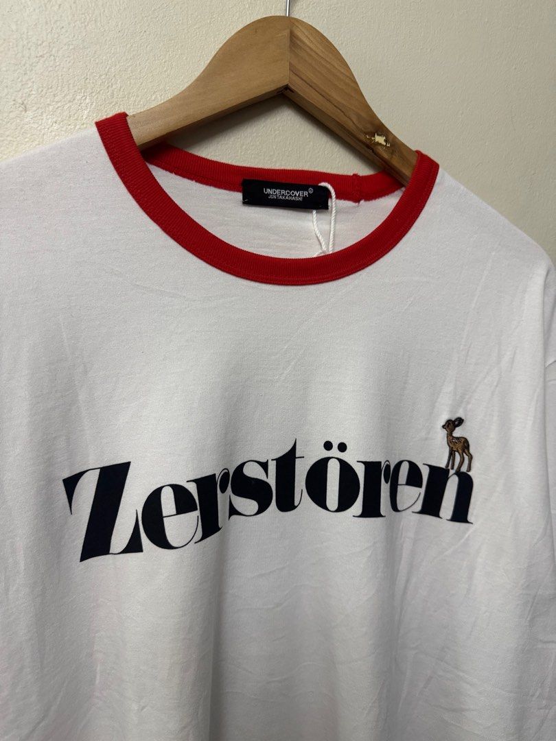 Undercover Japan Oversize Ringer Tee - White/Red (Category: Luxury Apparel) located in Dasmarinas. Submitted by phamhannii (Listing ID 1414013082, Image 2). Description: Undercover Japan by Jun Takahashi - Zerstören Graphic Oversize Ringer Tee 100% Cotton Size: 2 on tag Dimes (WxL): 24 x 28.5 inches Color Rate: 10/10 Condition Rate: 9.8/10 Excellent Condition (dot stain on belly area) All items are washed and sanitized. Flexible payment options. 