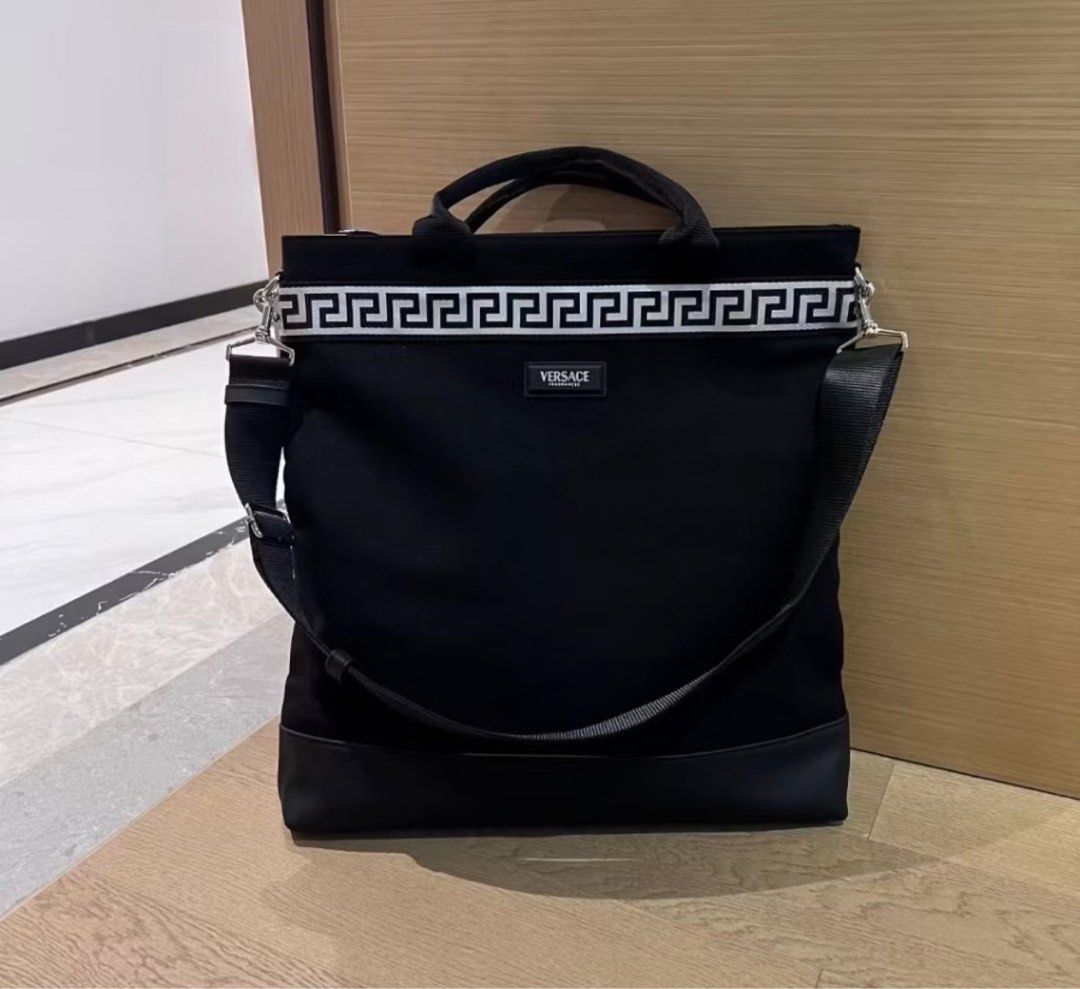 Versace Black Tote Bag with Shoulder Strap (Category: Luxury Bags & Wallets) located in Cebu City. Submitted by greatstuffshopper (Listing ID 1413928110, Image 1). Description: - Black Versace tote bag - White and black patterned trim - Top handle and detachable shoulder strap - Zippered main compartment - Fits a tablet - Lining: 100% polyester - Body: 85% cotton, 15% PU.