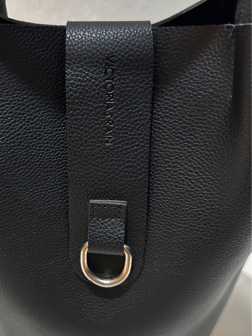 Victoria’s Rain Bucket Bag (Category: Luxury Bags & Wallets) located in Tarlac. Submitted by wearagainboutique (Listing ID 1413893774, Image 2). Description: - Victoria’s Rain bucket bag - Color: Black and cream - Top handle, with sling slot (no sling included) - Magnetic closure with silver ring detail - Textured exterior - Round base.