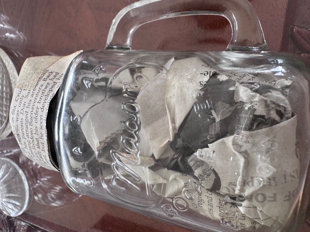 Vintage Mason Jar with Handle EACH (Category: Food Organization & Storage) located in Manila. Submitted by decluterthings888 (Listing ID 1413881817, Image 1). Description: - glass jar no cover good for coffee or drinks - Features classic Mason design - Filled with old newspaper clippings - Clear glass body - Includes handles for easy carrying - Ideal for display or repurposing.