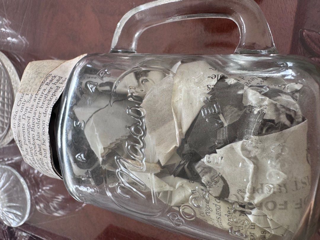 Vintage Mason Jar with Handle EACH (Category: Food Organization & Storage) located in Manila. Submitted by decluterthings888 (Listing ID 1413881817, Image 3). Description: - glass jar no cover good for coffee or drinks - Features classic Mason design - Filled with old newspaper clippings - Clear glass body - Includes handles for easy carrying - Ideal for display or repurposing.
