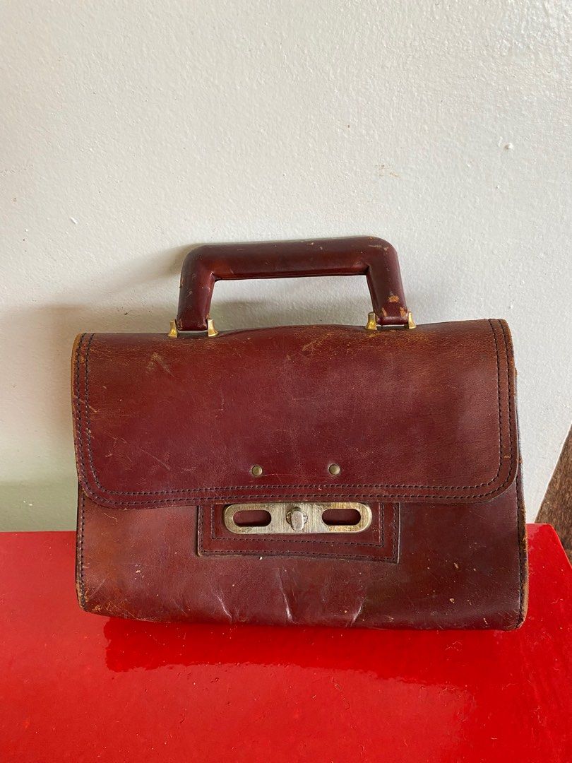 vintage small leather satchel handbag (Category: Luxury Bags & Wallets) located in Makati City. Submitted by celebrityauctions (Listing ID 1413985070, Image 1). Description: Vintage Distressed Brown Leather Small Satchel Handbag Up for sale is a unique and charming vintage small leather satchel handbag. This piece exudes a classic, time-worn appeal with a rich oxblood or burgundy hue that has developed a beautiful patina over time. It’s the perfe