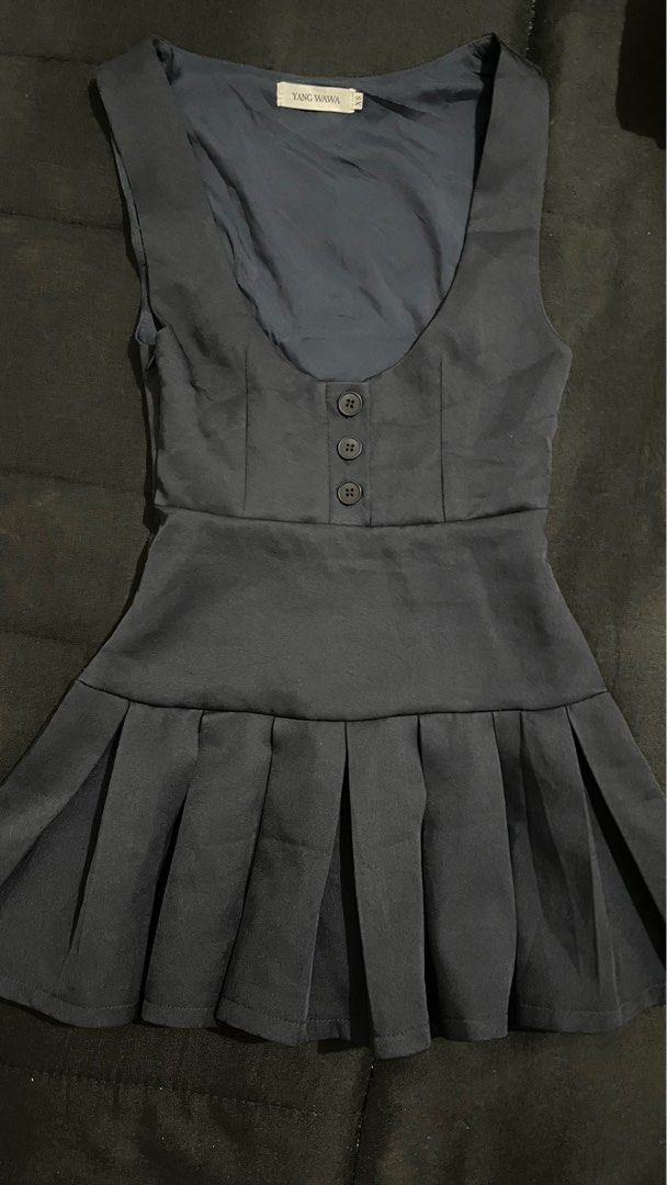 Yang Wawa Pleated Dress (Category: Dresses) located in Manila. Submitted by sushibakeee (Listing ID 1413957219, Image 1). Description: - Navy blue dress - Pleated skirt - Button details - Scoop neckline - Fitted bodice - Smooth, satin-like fabric - Brand tag visible.