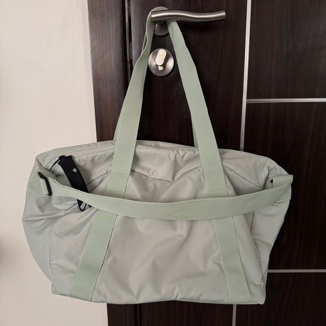 Adidas Training Duffle Bag (Category: Shoulder Bags) located in Manila. Submitted by declutterzoneee (Listing ID 1414104032, Image 3). Description: - Adidas training duffle bag - Light green color - Main compartment with zipper - Front pocket - Top handles and shoulder strap - Dark grey interior lining - Adidas logo on front.