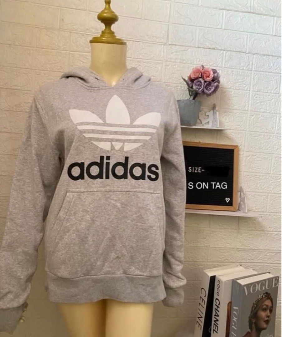 Adidas Trefoil Hoodie (Category: Hoodies) located in Bulacan. Submitted by jhemieee (Listing ID 1414076356, Image 2). Description: - Gray Adidas hoodie - Large white Trefoil logo on front - Adidas wordmark below logo - Kangaroo pocket - Drawstring hood - Standard fit.