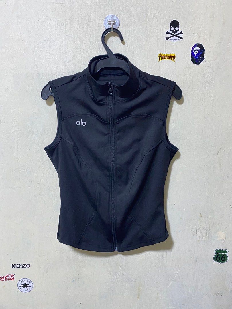Alo Black thin vest for jogging (Category: Vests) located in Manila. Submitted by drip-from-thrift (Listing ID 1414206899, Image 1). Description: - Alo black vest - Zip-up front - Size: M - Material: 82.5% polyester, 17.5% elastane - Features Alo logo - Made in China.