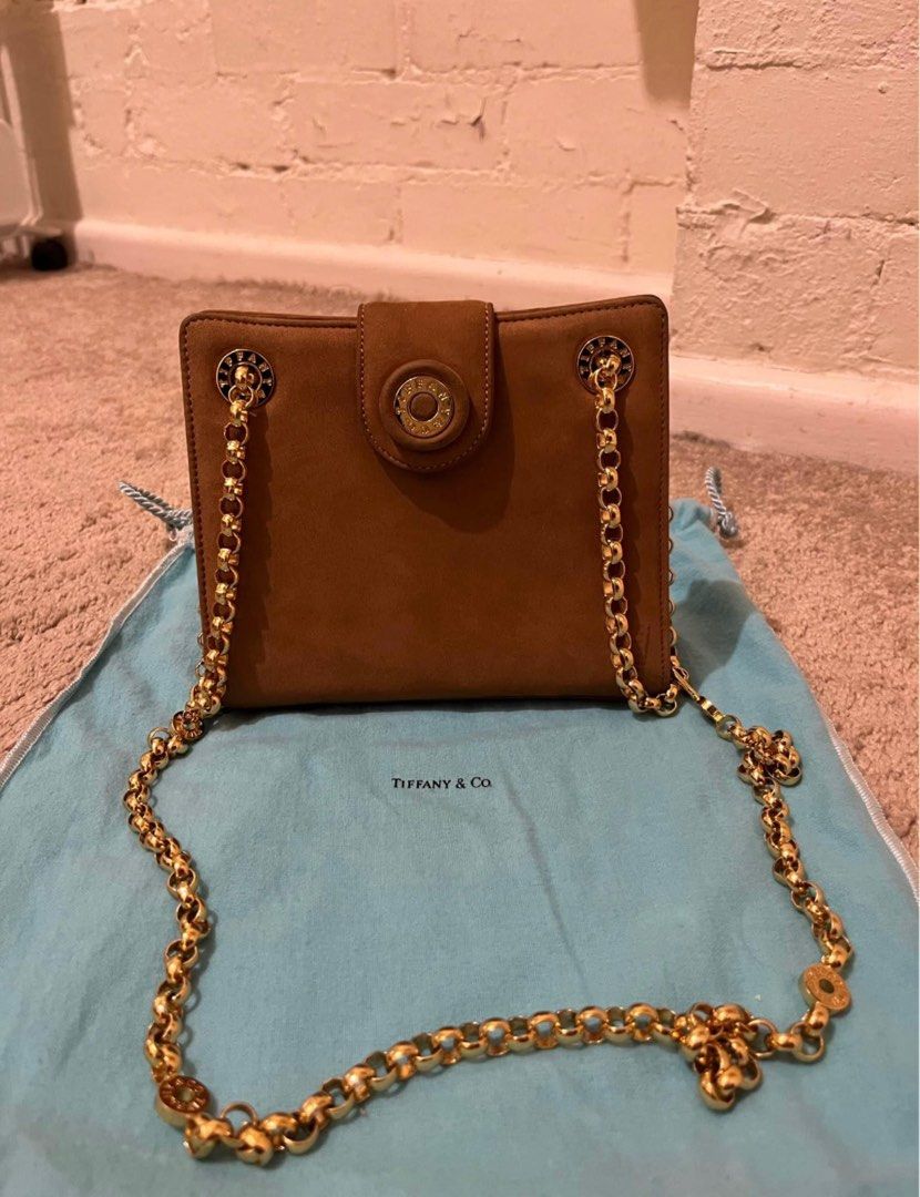 Authentic Vintage Tiffany & Co Chain Bag (Category: Luxury Bags & Wallets) located in Manila. Submitted by rvcr1694 (Listing ID 1414204861, Image 1). Description: Brown Suede Gold-Tone Hardware Chain-Link Shoulder Strap Suede Lining & Single Interior Pocket Snap Closure at Front Estimated item measurements Shoulder Strap Drop: 16.25” Height: 5.75” Width: 6.75” Depth: 1.5”.