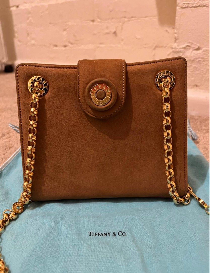 Authentic Vintage Tiffany & Co Chain Bag (Category: Luxury Bags & Wallets) located in Manila. Submitted by rvcr1694 (Listing ID 1414204861, Image 2). Description: Brown Suede Gold-Tone Hardware Chain-Link Shoulder Strap Suede Lining & Single Interior Pocket Snap Closure at Front Estimated item measurements Shoulder Strap Drop: 16.25” Height: 5.75” Width: 6.75” Depth: 1.5”.