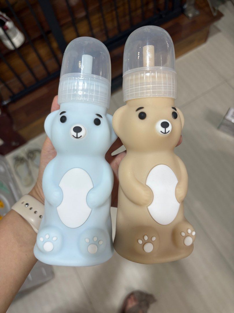 Bear-Shaped Baby silicon straw training Bottles (Category: Breastfeeding & Bottle Feeding) located in Manila. Submitted by chandleria (Listing ID 1414117226, Image 1). Description: - Adorable bear-shaped baby bottles - Available in blue and brown - Features clear cap and white teat - Designed with bear features (eyes, nose, paw prints) - Perfect for stylish feeding ideal for babies teaching to use straw price is each or take both at a discounted 