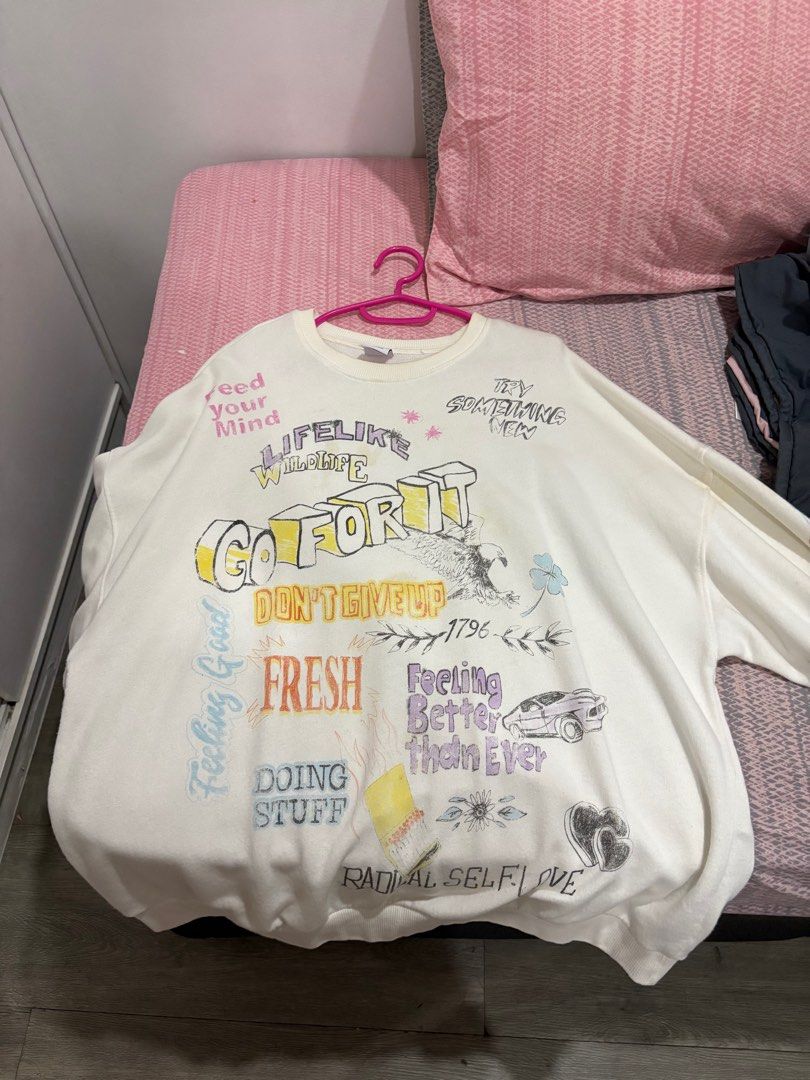 Bershka Graphic Sweatshirt - Size M (Category: Coats, Jackets and Outerwear) located in Manila. Submitted by svphiiaaa (Listing ID 1414113941, Image 1). Description: - Bershka sweatshirt - Features graphic prints - Crew neck - Long sleeves - Size: M - Few defects .