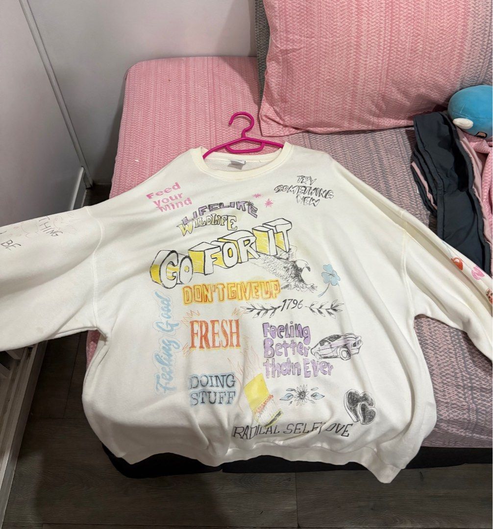 Bershka Graphic Sweatshirt - Size M (Category: Coats, Jackets and Outerwear) located in Manila. Submitted by svphiiaaa (Listing ID 1414113941, Image 2). Description: - Bershka sweatshirt - Features graphic prints - Crew neck - Long sleeves - Size: M - Few defects .