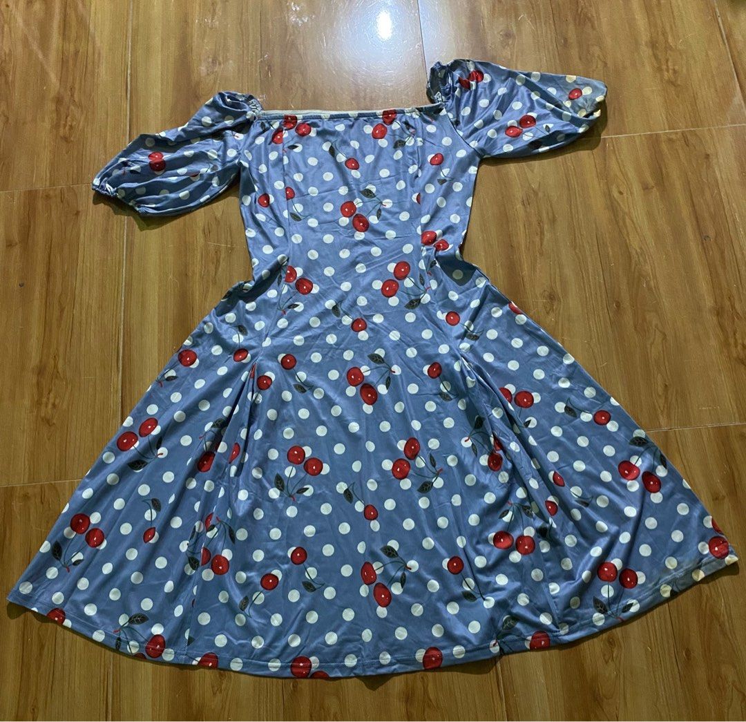 Cherry Print Off-Shoulder Dress (Category: Dresses) located in Cagayan de Oro. Submitted by ecolive (Listing ID 1414064949, Image 1). Description: - Off-shoulder design - Short, puffy sleeves - Blue background with white polka dots and red cherry prints - Flared skirt - Lightweight fabric - Suitable for warm weather - Cute and playful style.