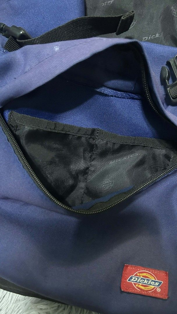 Dickies Backpack (Category: Backpacks) located in Manila. Submitted by orlacoyam89725 (Listing ID 1414169465, Image 3). Description: - Dickies backpack - Color: Blue and Black - Front pocket - Side pockets - Adjustable shoulder straps - Interior: Dickies logo pattern - Condition: Minor tear on one shoulder strap - Perfect for everyday use.