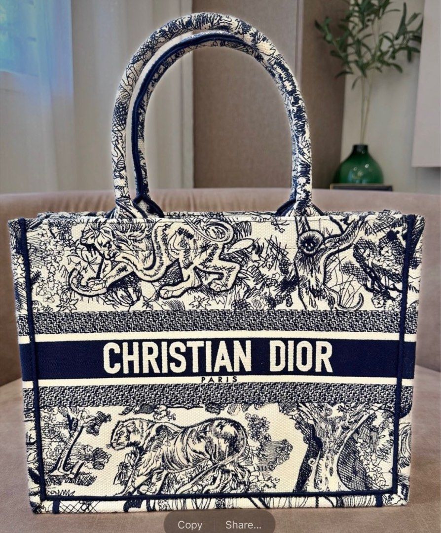DIOR BOOK TOTE (Category: Tote Bags) located in Davao. Submitted by jafffff (Listing ID 1414242166, Image 1). Description: DIOR BOOK TOTE WITH DUST BAG HAS STAIN (orange juice at the back of the bag) .