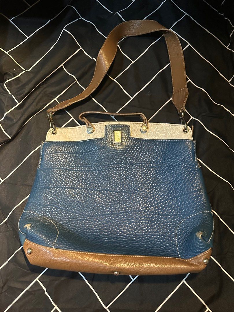 Furla Piper Leather 2-way Bag (Category: Luxury Bags & Wallets) located in Manila. Submitted by fiercefish-eaf55c (Listing ID 1414110046, Image 1). Description: - Furla Piper 2-way bag - Blue leather body with brown accents - Top handle and shoulder strap included - Rectangular shape with flap closure.
