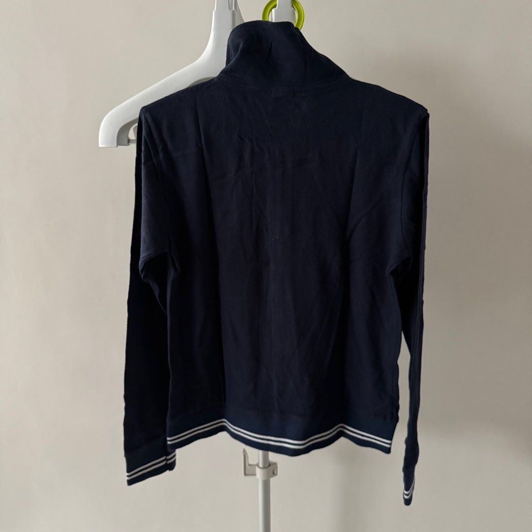 GAP Navy Blue Zip-Up Jacket (Category: Coats, Jackets and Outerwear) located in Manila. Submitted by declutterzoneee (Listing ID 1414104605, Image 3). Description: - GAP navy blue zip-up jacket - Color: Navy blue - Features a high collar - Red "5" patch on the chest - White stripe detail on cuffs and hem - Material: 100% cotton - Size: S.
