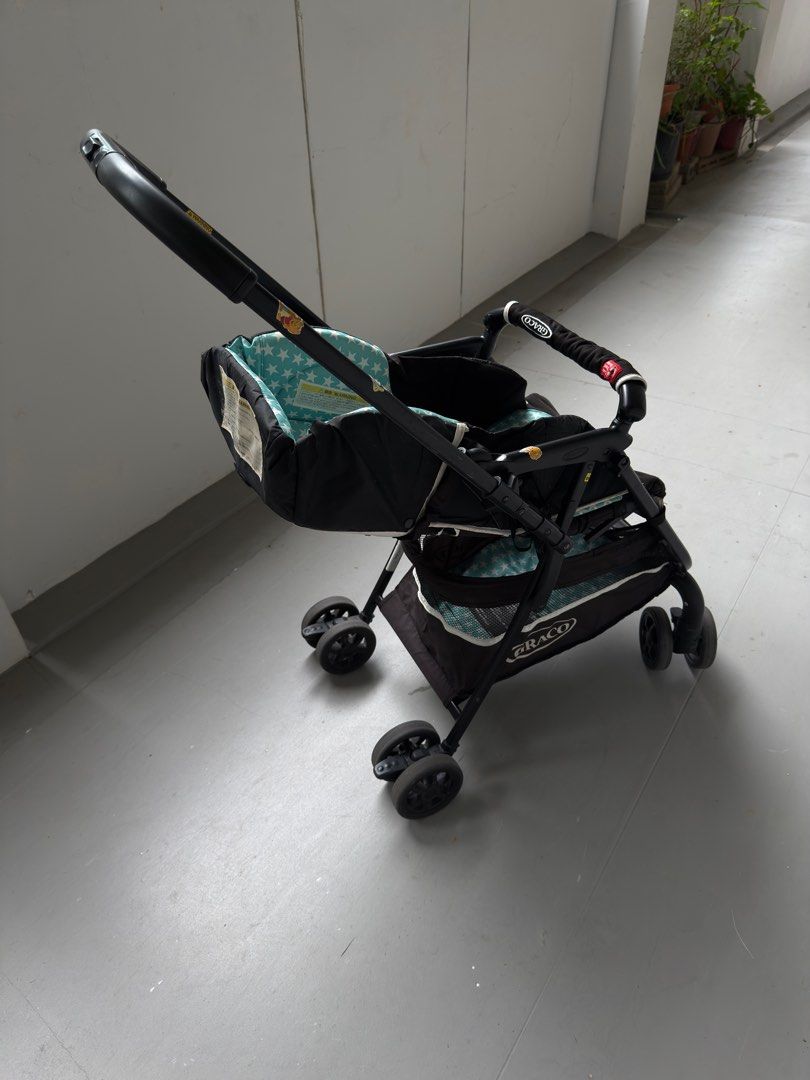 Graco Stroller (Category: Strollers) located in Singapore. Submitted by kjlw78 (Listing ID 1414114721, Image 2). Description: - Teal star-patterned seat - Black frame - Includes storage basket - Suitable for everyday use - Some wear and tear present.