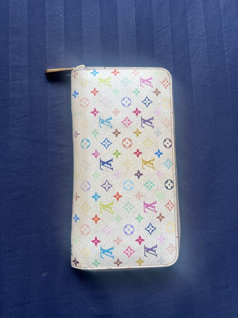 Louis Vuitton 2013 Murakami Multicolored Zippy Wallet (Category: Luxury Bags & Wallets) located in Manila. Submitted by misskishan96 (Listing ID 1414118145, Image 2). Description: An eye-catching multicolored wallet! Definitely a need if you want a very classic splash of LV monograms into your everyday wardrobe 💖 Brand: Louis Vuitton Material: Leather Color: Murakami Multicolor Condition: Used Retail Price: $940 Inclusions: Wallet only .