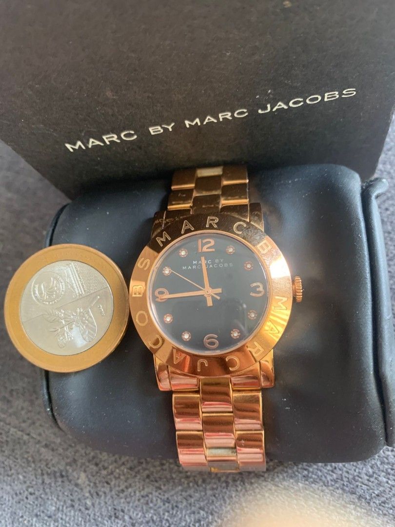 Marc by Marc Jacobs Rose Gold Watch (Category: Women's Watches) located in Bacoor. Submitted by sharmaine55 (Listing ID 1414142510, Image 1). Description: Elegant Pre-loved Marc by Marc Jacobs watch in rose gold. Features a dark face with diamond accents and the brand name around the bezel. Includes the original box. The watch has a matching rose gold bracelet strap. Original Marc Jacobs Women Watch - 5500 Guaranteed Original Market Price - P 12k