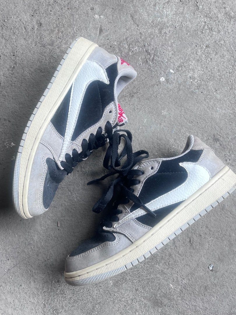 Nike Air Jordan 1 Low Travis Scott (Category: Sneakers) located in Tuguegarao City. Submitted by preloved_rx (Listing ID 1414078684, Image 2). Description: Nike Air Jordan 1 Low sneakers. Features a black, grey, and white color scheme. The shoes have black laces and the Nike Air logo is visible on the insole. The size tag indicates a size 4 for US women's. The soles show some wear. Can offer! Rfs- hindi na kasya.