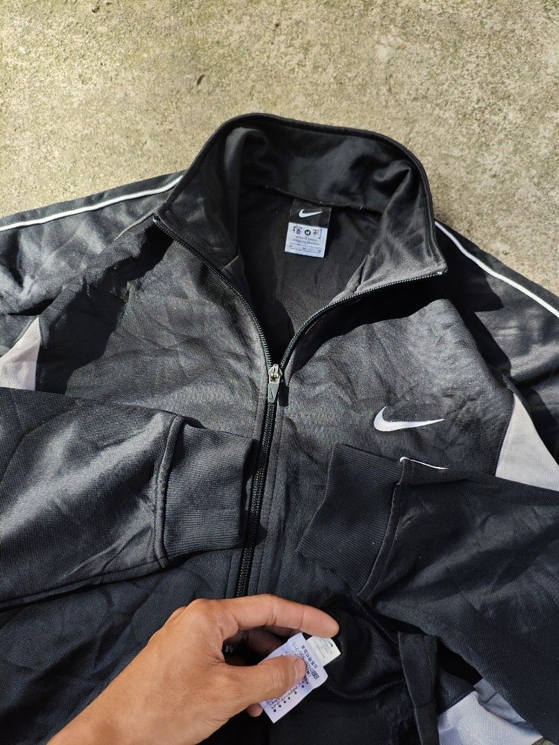 NIKE FULL ZIP EMBROIDERED SWOOSH TRACK JACKET (Category: Coats, Jackets and Outerwear) located in Cavite. Submitted by grailedthings_ (Listing ID 1414139019, Image 2). Description: NIKE FULL ZIP EMBROIDERED SWOOSH TRACK JACKET 21x27 EXCELLENT CONDITION NO ISSUE.