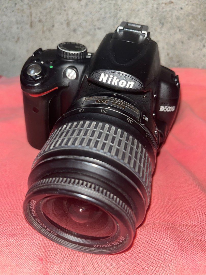 Nikon D5000 DSLR Camera with Lens (Category: Cameras) located in Bongabong. Submitted by theamariano (Listing ID 1414127333, Image 1). Description: - Nikon D5000 DSLR camera - Includes AF-S DX NIKKOR 18-55mm 1:3.5-5.6G lens - Black camera body - Features built-in flash - Zoom lens functionality.