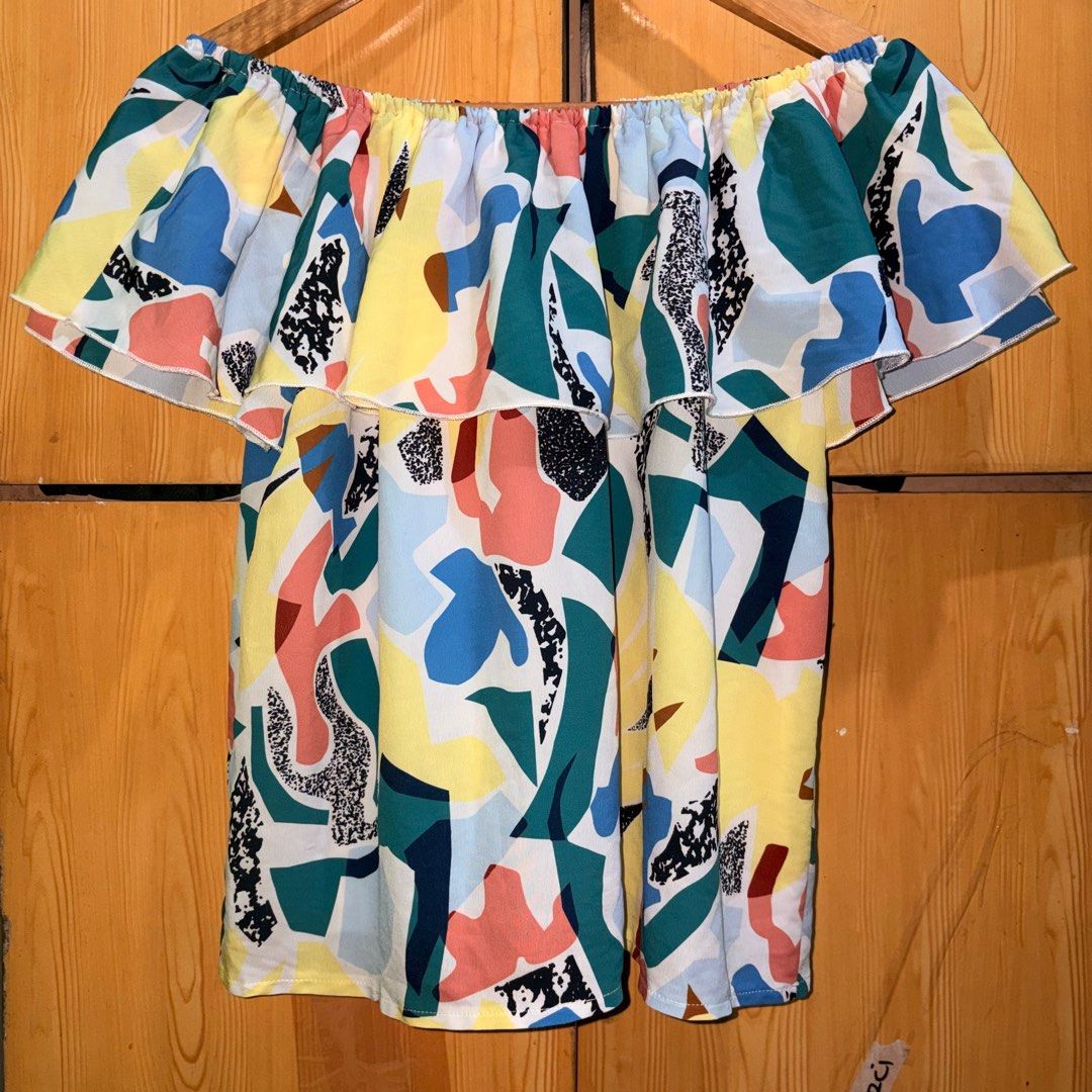Off-Shoulder Ruffle Top (Category: Blouses) located in Manila. Submitted by ciiii1 (Listing ID 1414215450, Image 2). Description: Off-shoulder top with vibrant abstract print and layered ruffles. Relaxed fit, lightweight fabric. Colors: yellow, blue, green, pink. Great for casual wear..